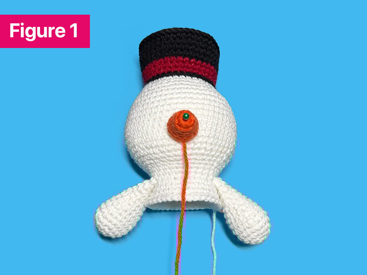 How to Crochet a Snowman Step 1: Sewing on the Nose
